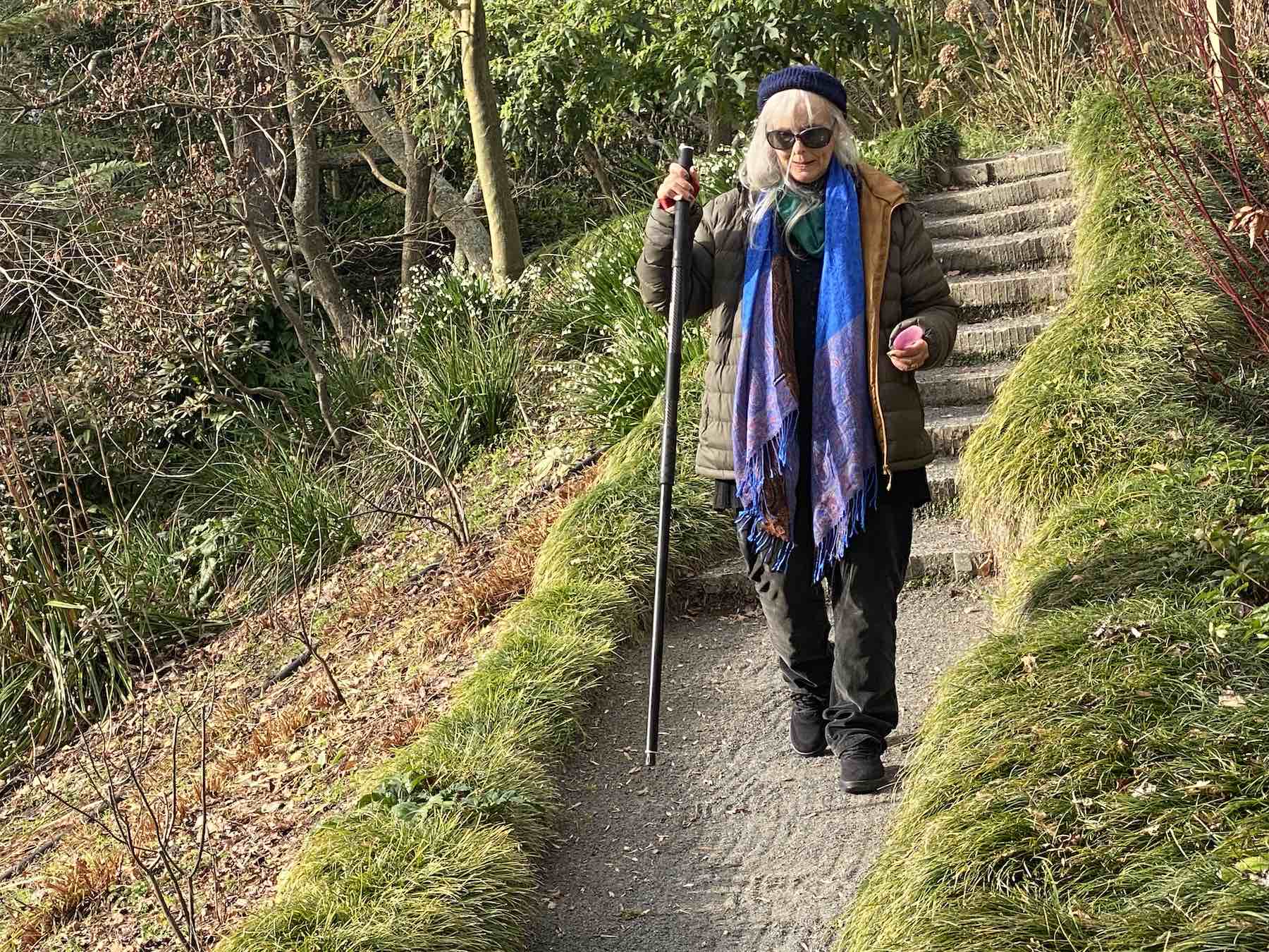 Older woman using Stowt Staff on garden steps